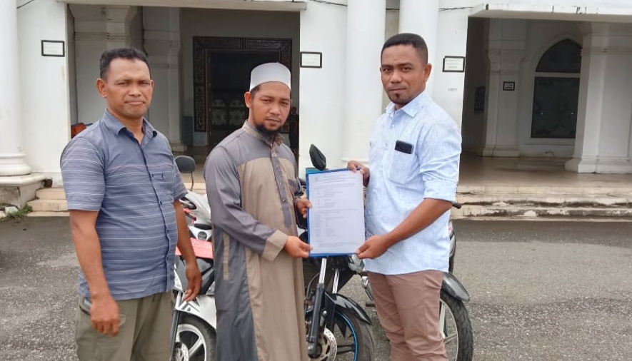 Plt Kabag Kesra Kespul Basiludin La Besi (kanan) saat menyerahkan bantuan tiga unit sepeda motor dan laptop kepada pengurus masjid Al-Istiqomah Sanana, Kamis (24/12/2020)