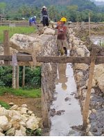 ILUSTRASI pekerjaan bendungan irigasi menggunakan batu kapur